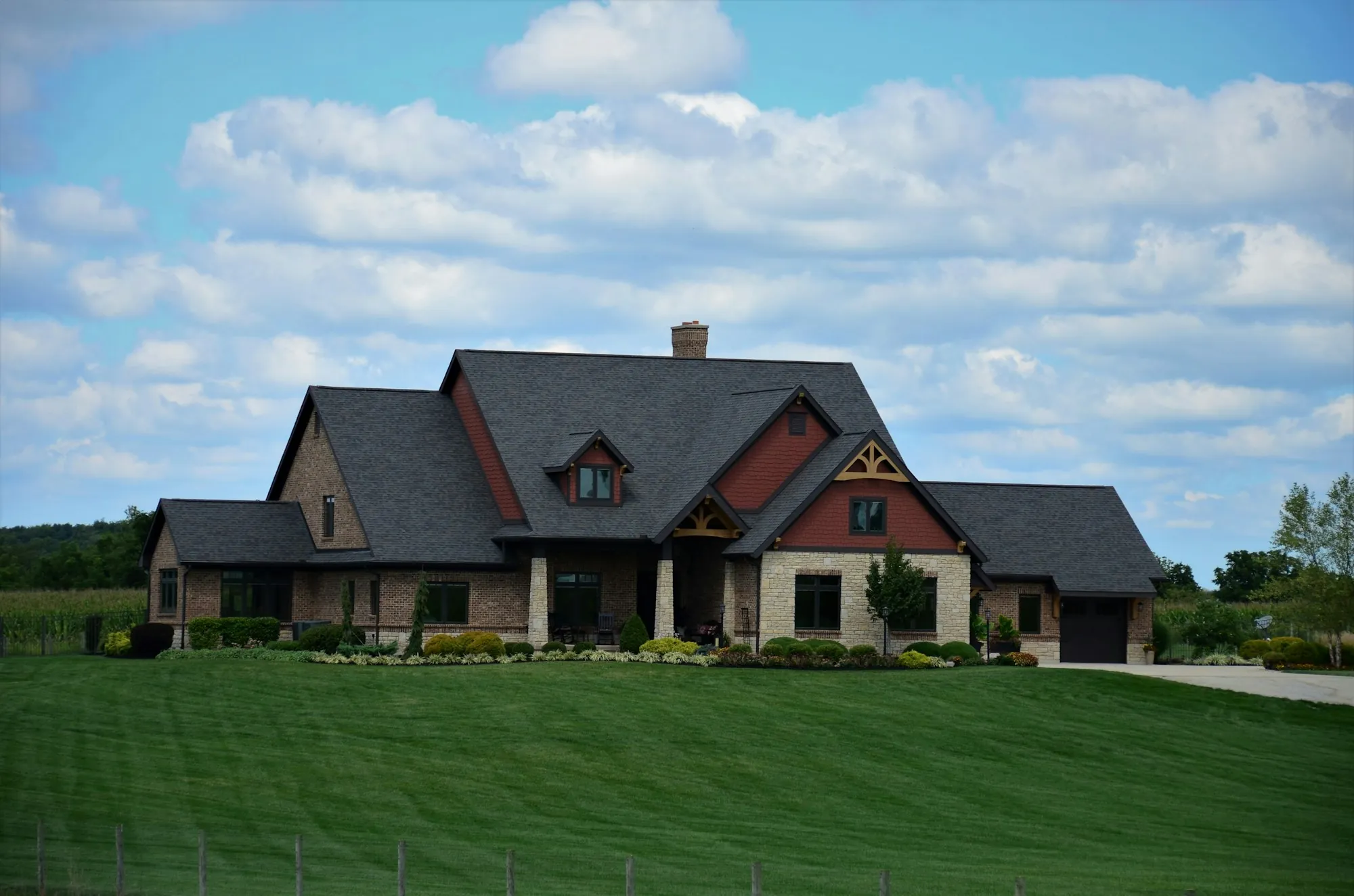 Craftsman style house with a green lawn and blue sky