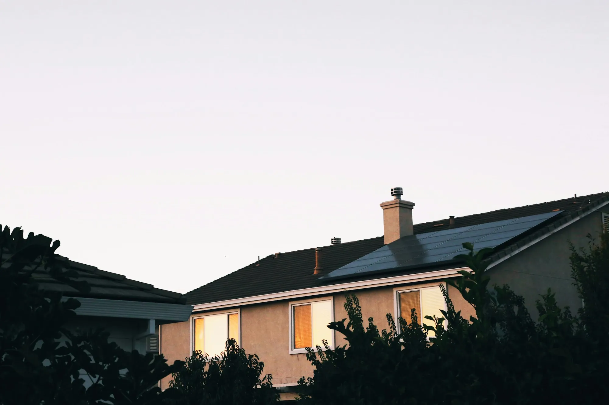 Suburban house with lit windows at twilight